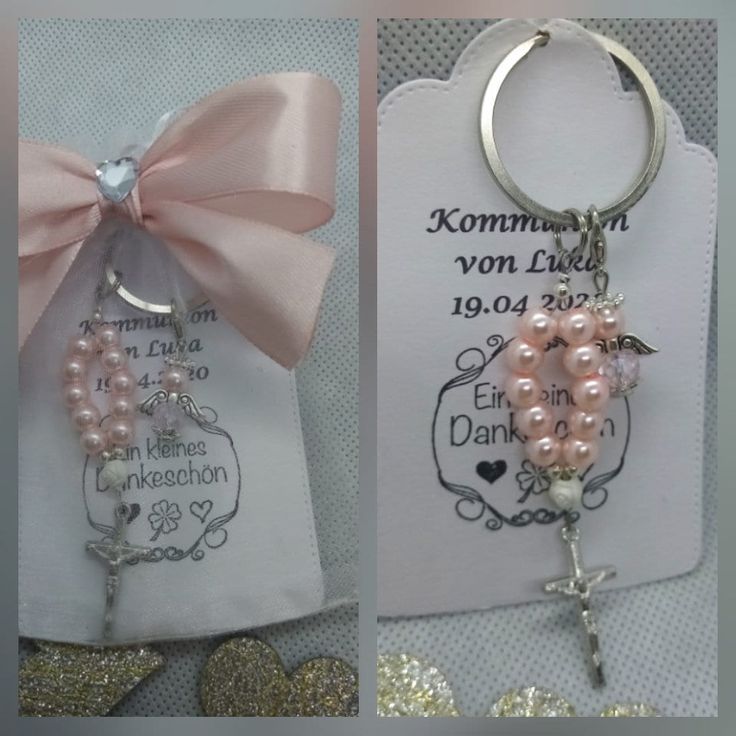 two key chains with pink pearls on them and a cross hanging from the front one