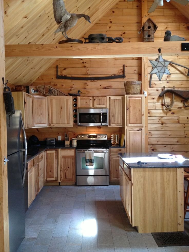 a kitchen with wood paneling and stainless steel appliances