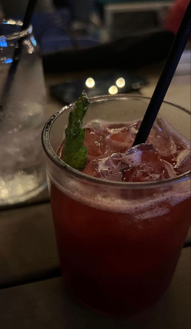 a close up of a drink in a glass on a table