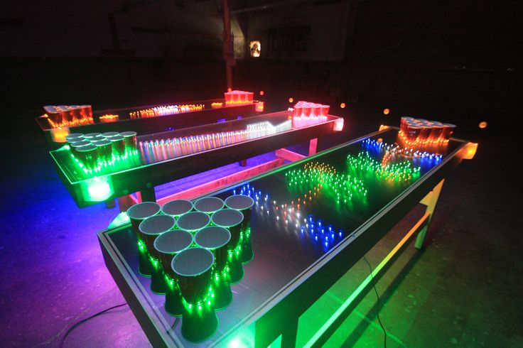 an illuminated table with cups and lights on it