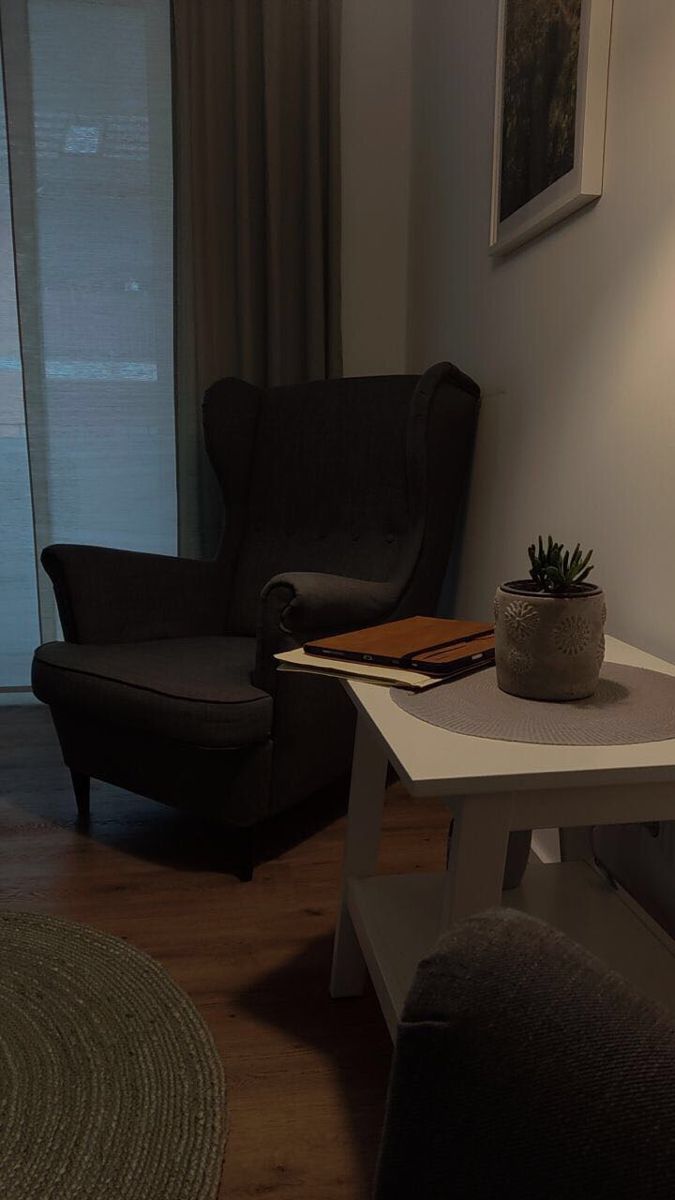 a living room with two chairs and a table