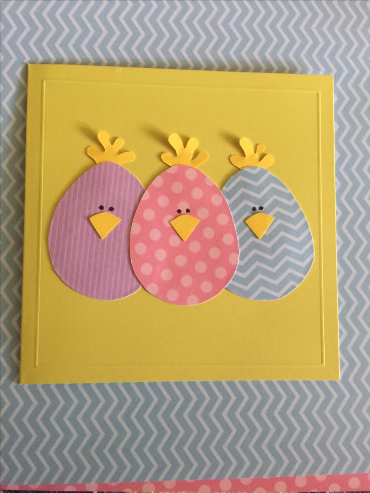 three paper birds sitting on top of a yellow and blue card with polka dot dots