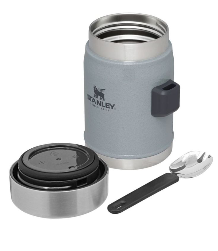 thermos and spoons are set up next to a stainless steel canister