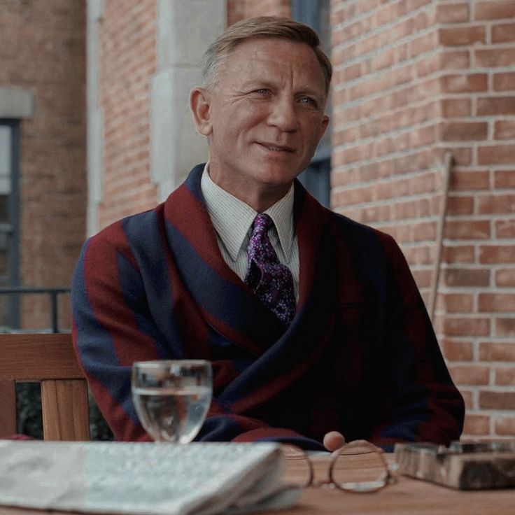 a man in a suit and tie sitting at a table