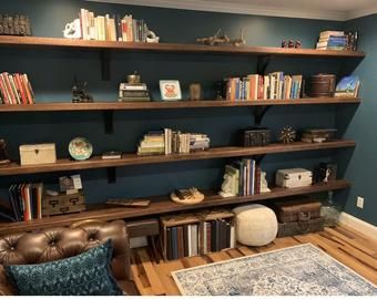 a living room filled with furniture and bookshelves