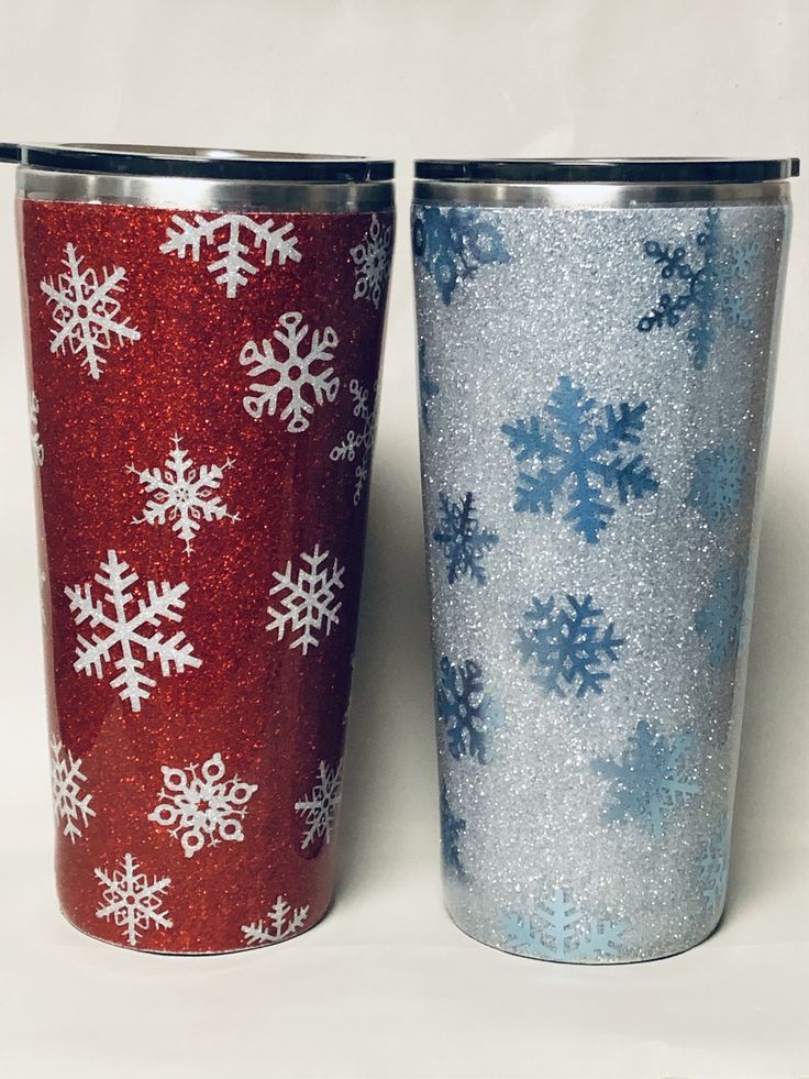 two red and blue tumblers with snowflakes on them are sitting side by side