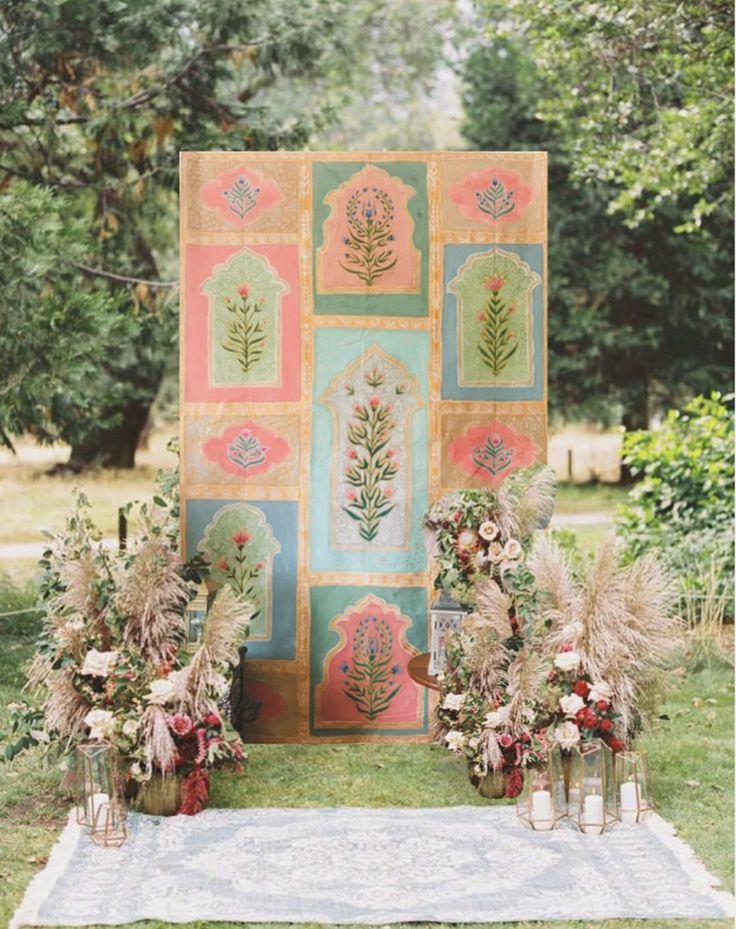 an outdoor ceremony setup with flowers and greenery