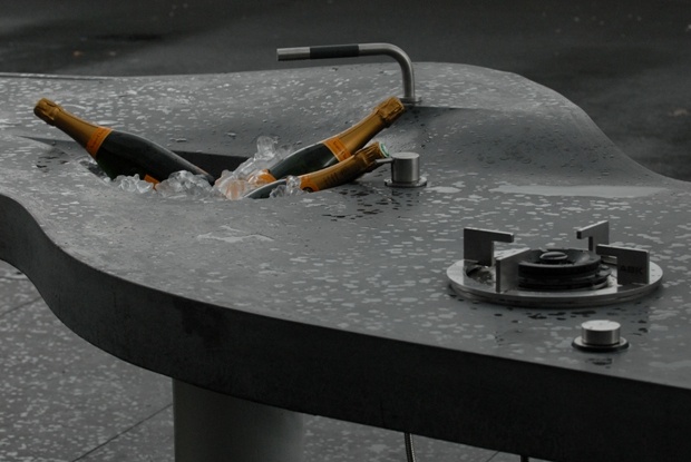 two bottles are in the water on top of a metal table that is partially submerged