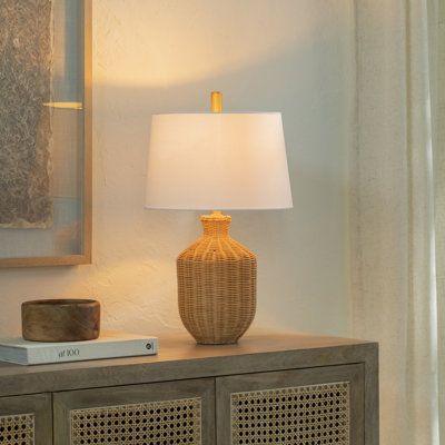 Light and breezy. Our table lamp's woven rattan base offers a casually refined look, perfect for boho chic or coastal-inspired spaces. The voluminous silhouette showcases natural textures and a warm artisanal appeal. A white linen shade softly diffuses light, brightening up your side table, console, or nightstand. Plus, the rotary socket switch makes it easy to set the mood just right. Something to keep in mind: a bulb is sold separately. Joss & Main | Joss & Main Kelta Table Lamp in Brown | Siz Rattan Table, Table Console, Minimal Space, Entryway Console, Fixture Table, Buffet Lamps, Woven Rattan, Metal Lamp, Curtain Accessories