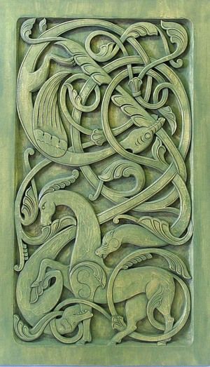 an intricately carved design on the side of a building with animals and vines in it