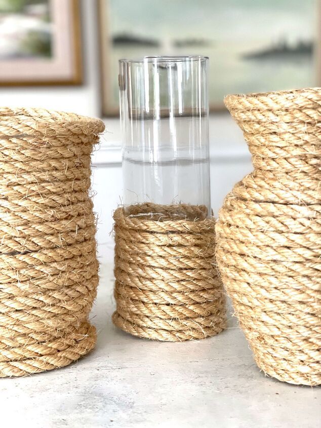 three rope wrapped vases sitting on top of a table