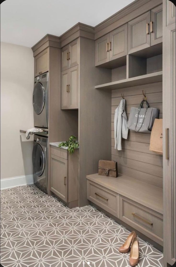 a washer, dryer and cabinets in a room