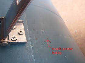 the screws are attached to the side of a metal object with an arrow pointing towards it