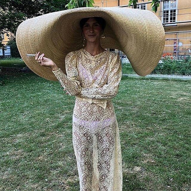 a woman with a large hat on her head