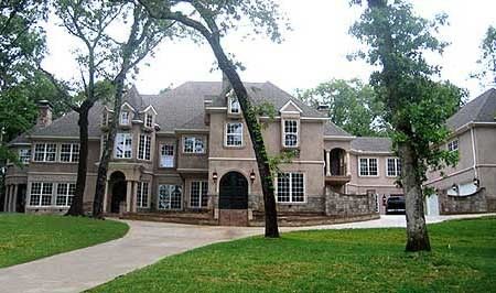 a large house with trees in front of it