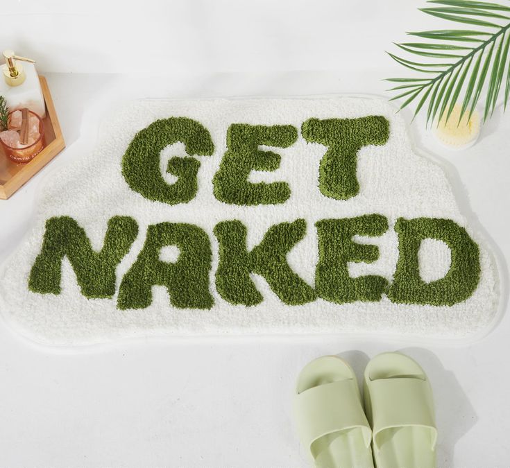 a rug that says get naked next to slippers