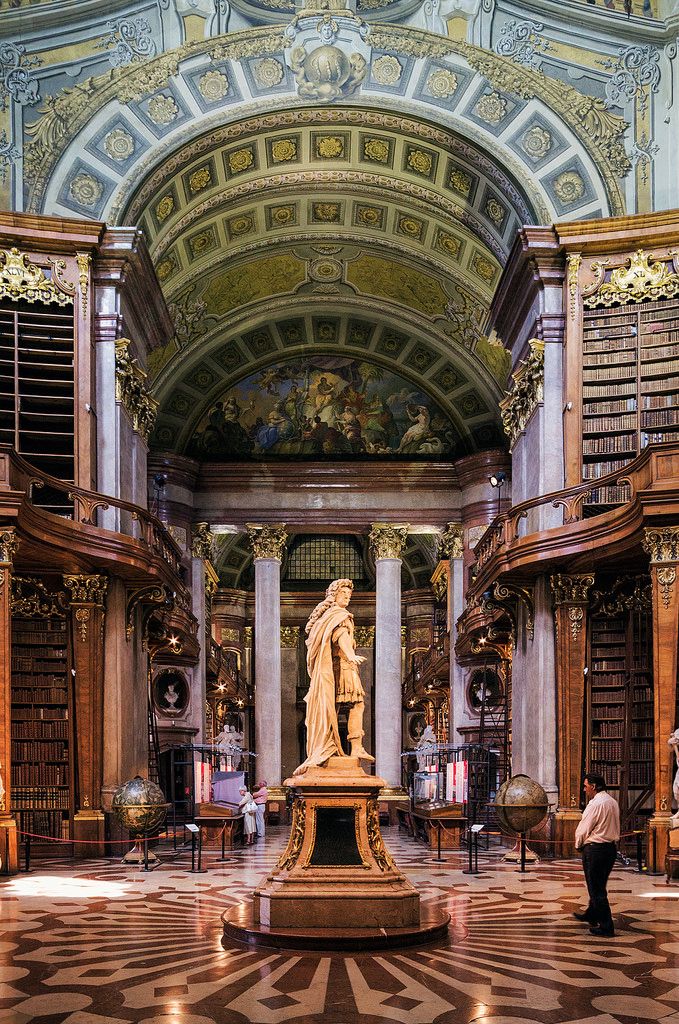 a statue in the middle of a library