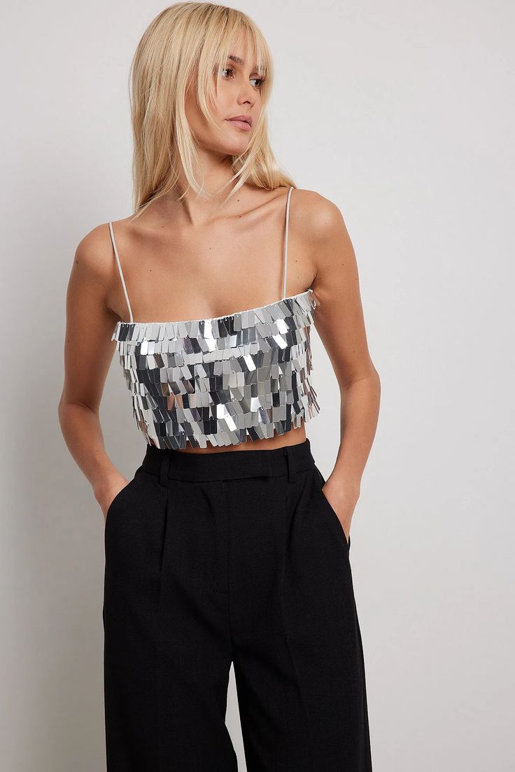 This top is lined and non-stretchy and features a square sequin materialIt has shoulder straps and cropped length.