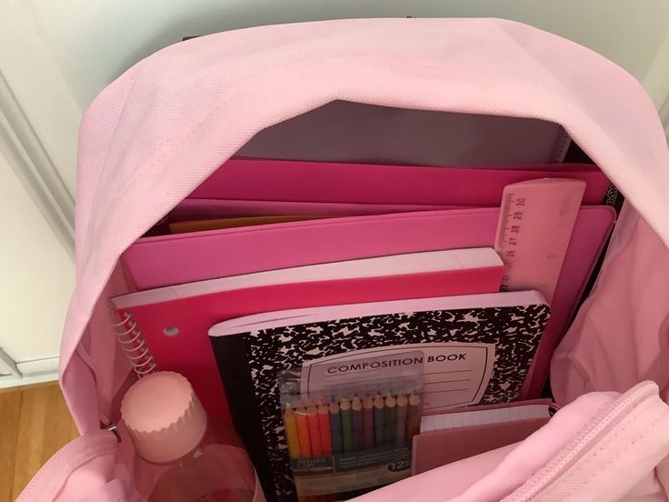 a pink backpack filled with books and school supplies