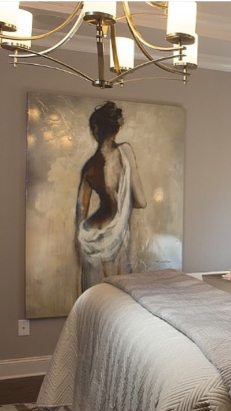 a bedroom with a large painting on the wall