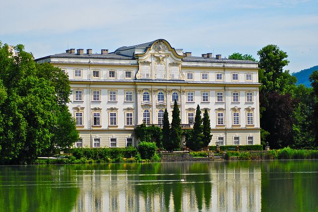 a large white building sitting on top of a lake