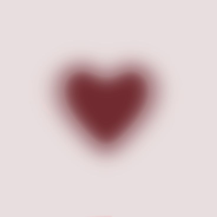 a blurry red heart on a white background