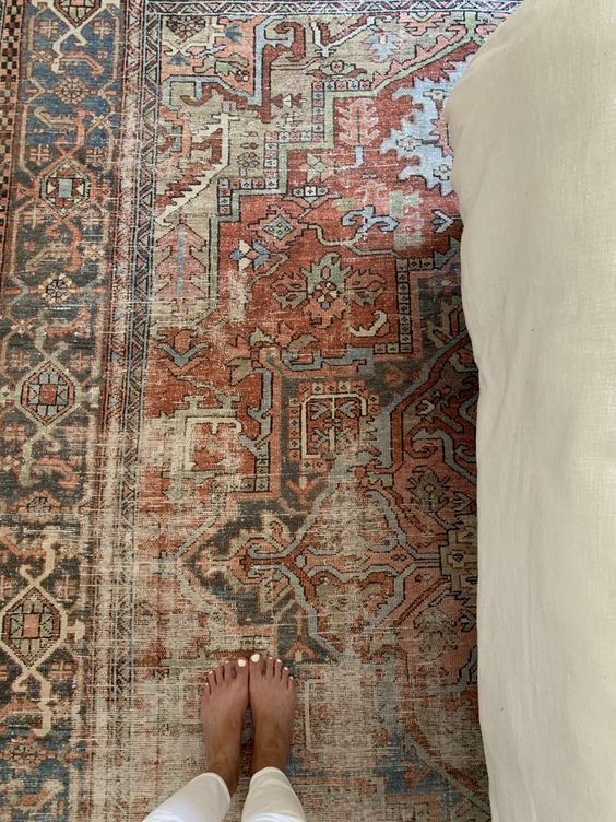 a person standing on top of a rug with their feet up in front of it