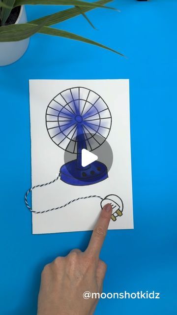 a hand pointing at a blue and white fan