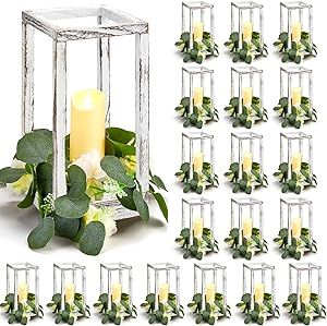 a bunch of candles are sitting in a cage with flowers and greenery around it