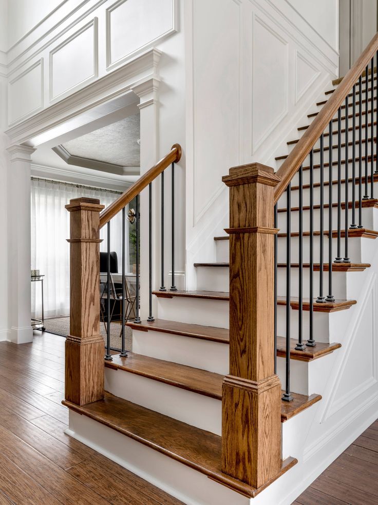 a wooden staircase with metal handrails in a home