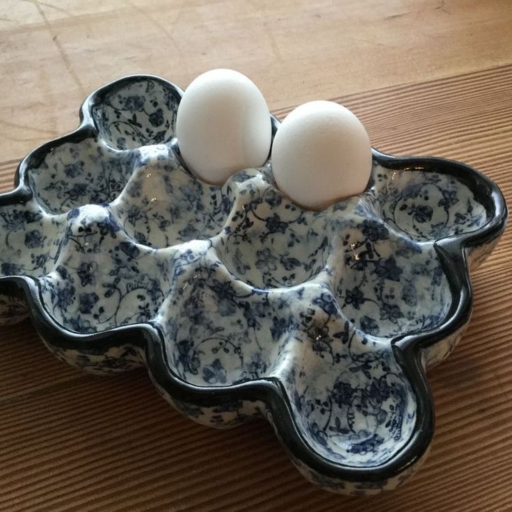 three eggs are in an egg tray on the table