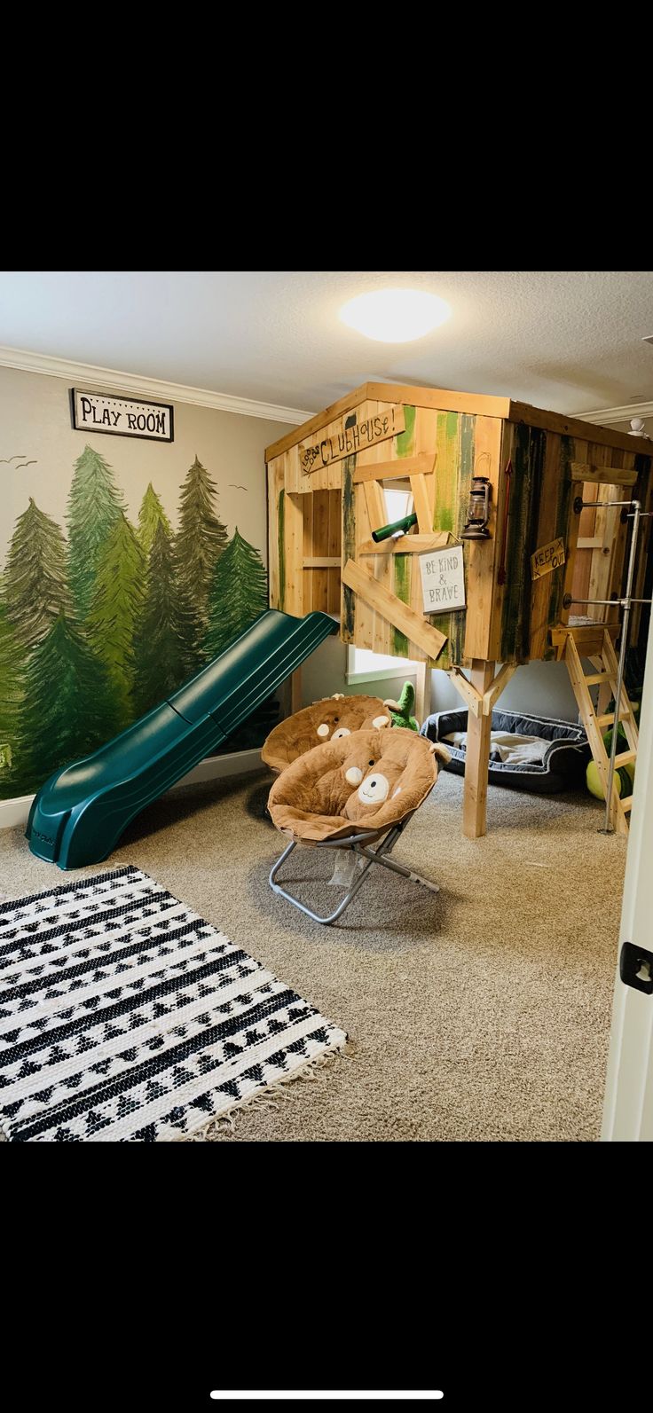 a room with a slide and play equipment in it