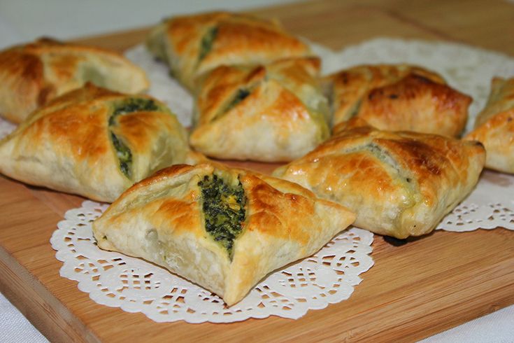 several small pastries on a wooden cutting board