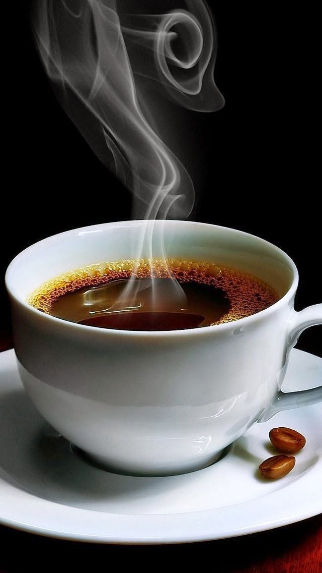 a cup of coffee with steam rising from it