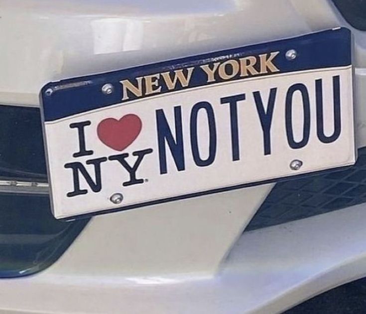 a new york license plate that says i love ny not you on the front of a white car