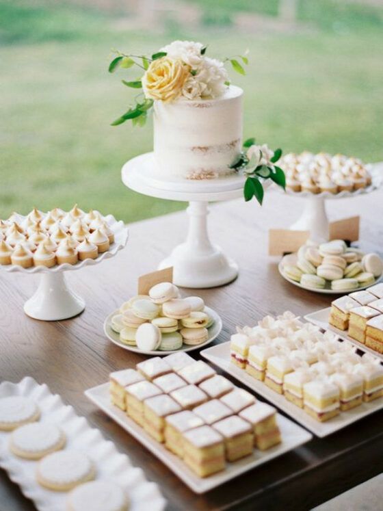 a table topped with lots of cakes and desserts