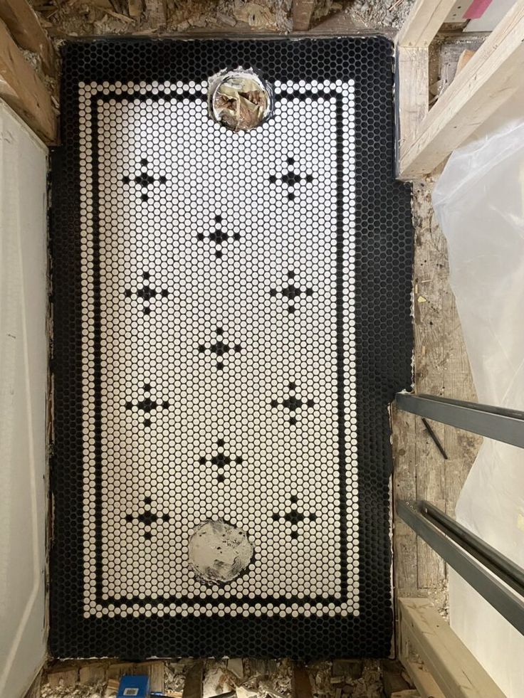 a black and white rug hanging on the side of a wall