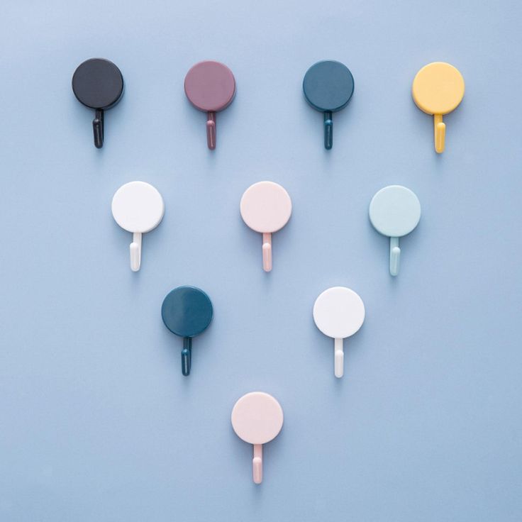 several different colored ping pong paddles on a blue background