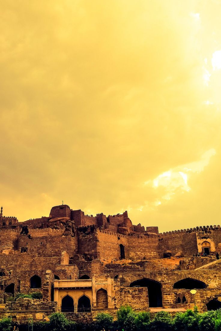 an old castle is sitting on top of a hill