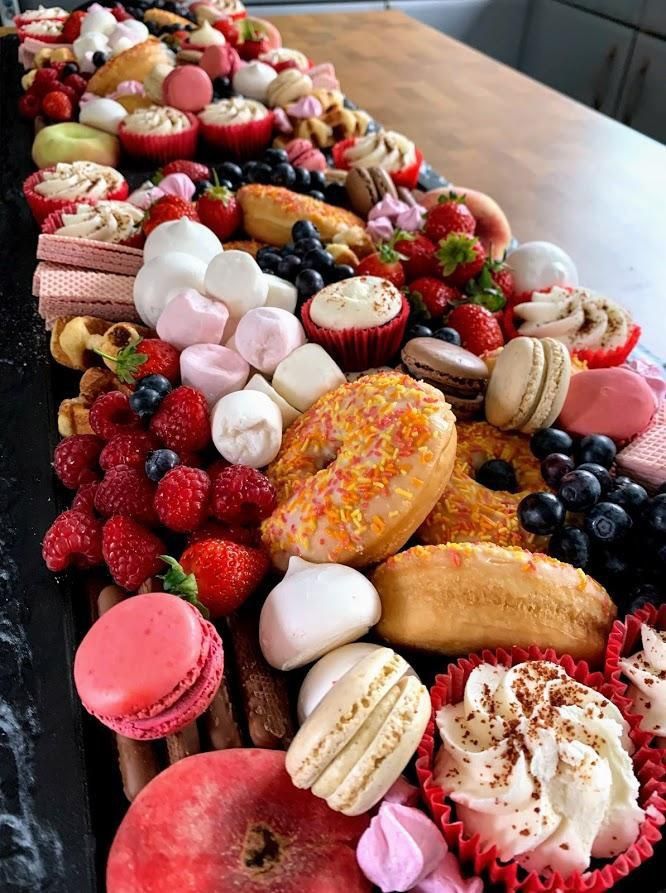 an assortment of pastries are lined up on a table