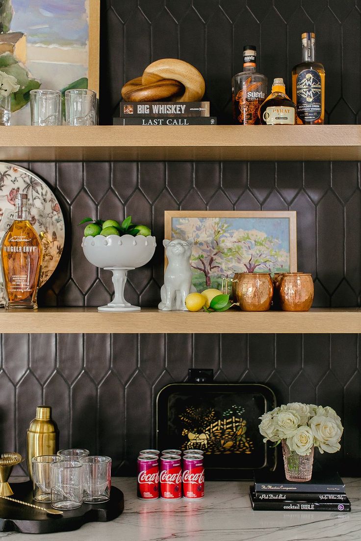 the shelves in this kitchen are filled with different types of drinks and food, including lemons