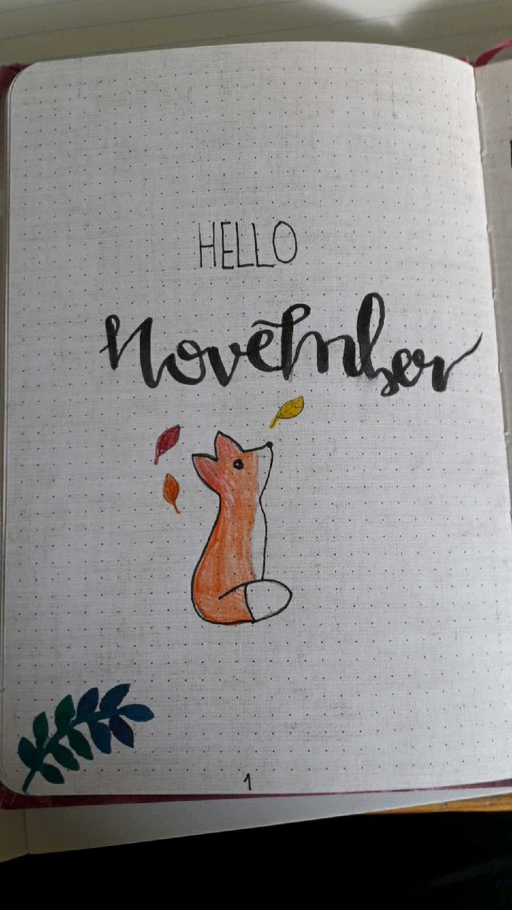 an open notebook with the words hello november written in black and orange ink on it