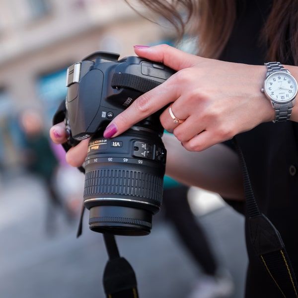 a woman holding a camera in her hand