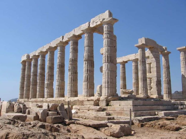 an ancient temple in the desert with many columns and pillars on it's sides