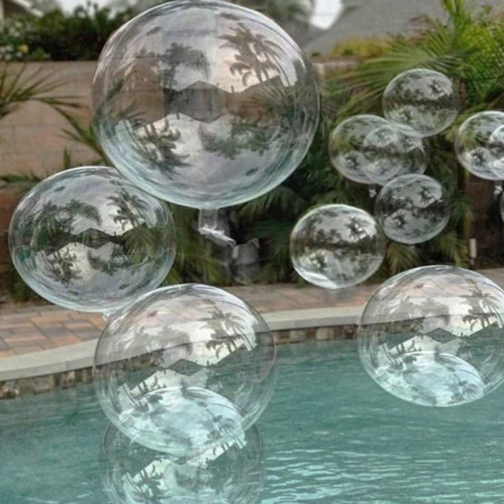 some clear bubbles floating in the air near a pool