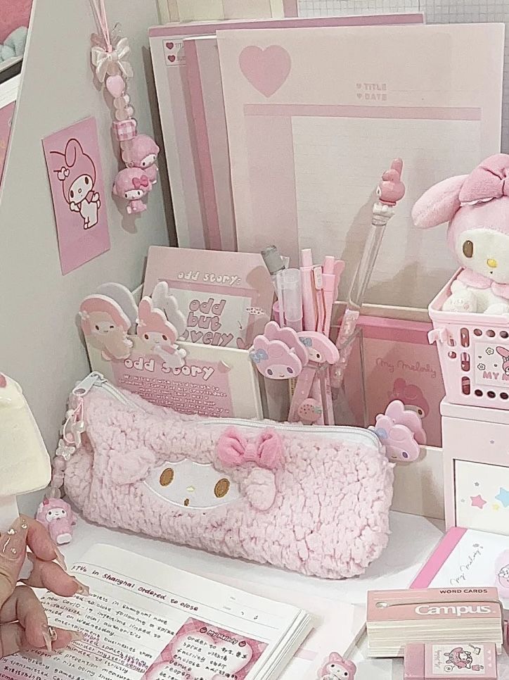 a pink hello kitty themed desk with many items