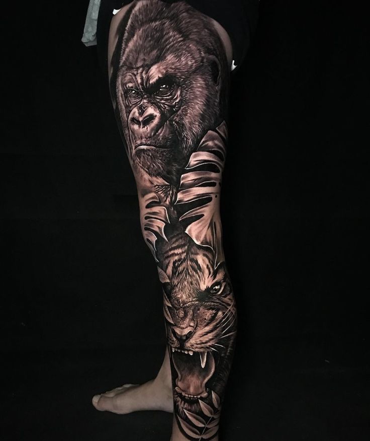 a man's leg with tattoos on it that has a gorilla and tiger on it