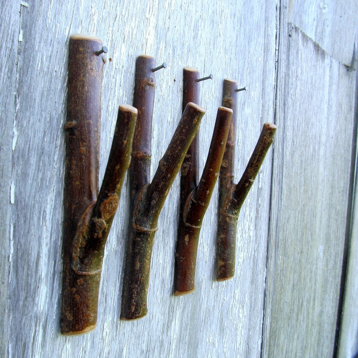 four pieces of wood that have been used to make something out of sticks on the side of a building