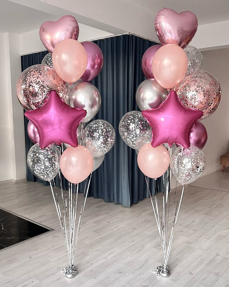 pink and silver balloons are in the shape of stars