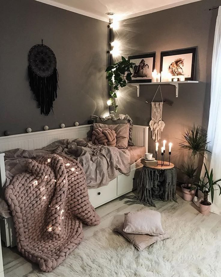 a bed room with a neatly made bed next to a night stand and some plants